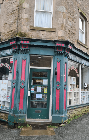 The Kettlewell Village Store is another stone building with its wood detailing painted in vibrant colours, in this case teal and pink.