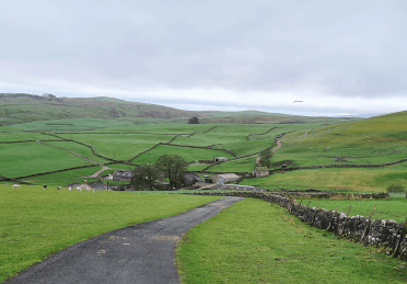 Yorkshire's green hills, split into patchwork fields by stone walls, are a common view on the Three Dales Way.
