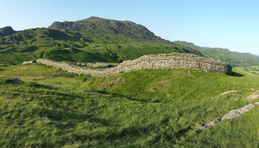 Hardknott Panorama by Alx_Chief. The stone remains of an old Roman fort sit atop green Lakeland hills.