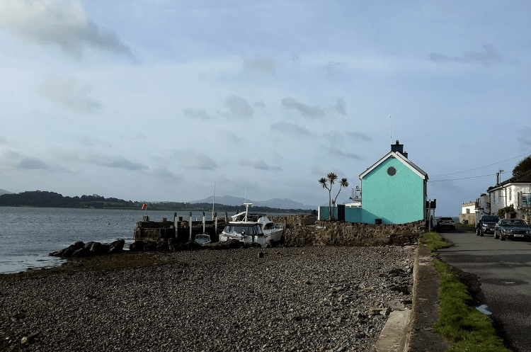 A blue pub building above the waves