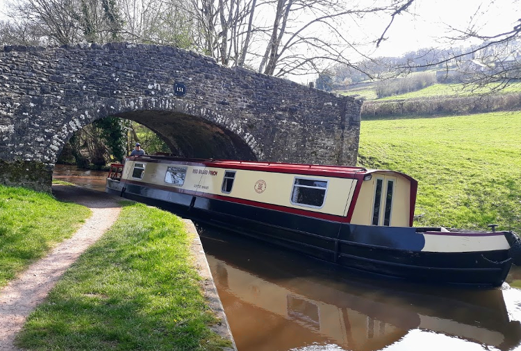 Usk Valley Walk: boat passes under bridge