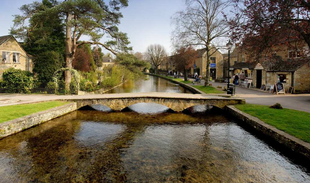 A low bridge crosses a pretty river in Bourton-on-the-Water