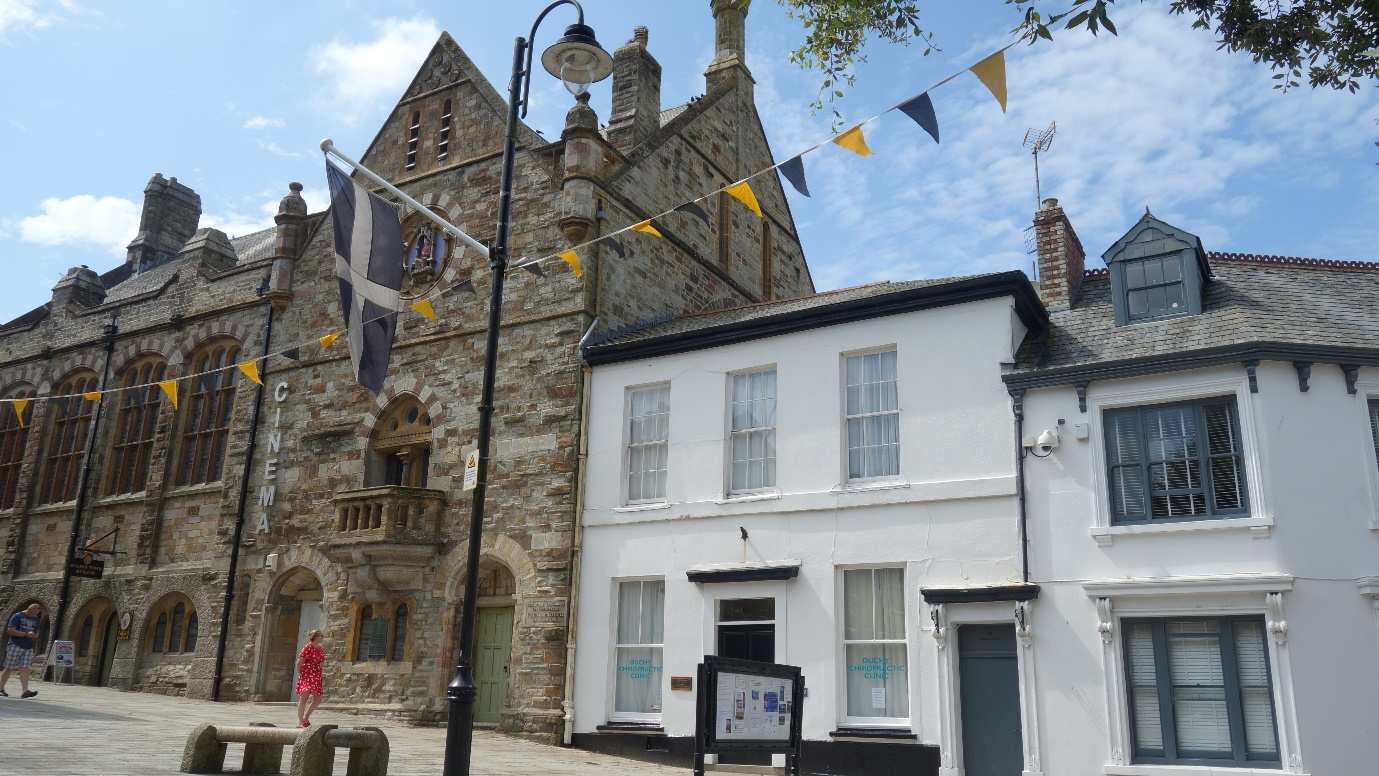 The Cornish flag flies outside traditional buildings