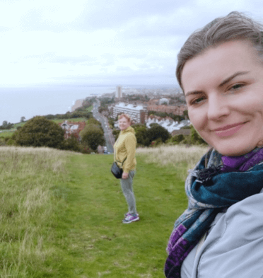 Gosia takes a selfie with her cowalker with views down to Eastbourne.