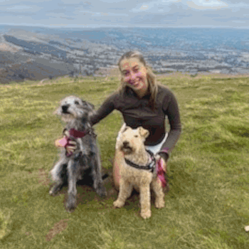 Emily, database administrator, out in the UK countryside with her two dogs Bella and Tilly.