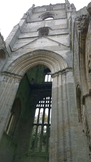 Sculpted stone arches above the windows of Fountain Abbey's tower.