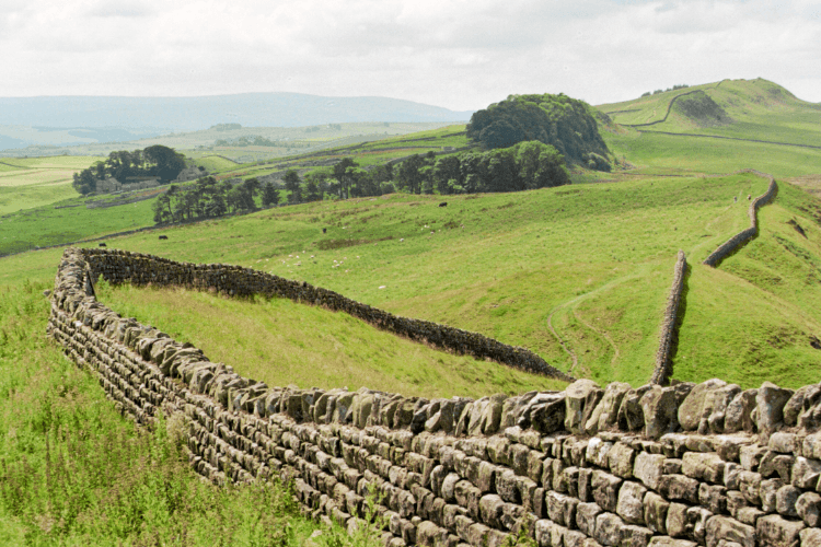 Views of Hadrian's Wall crossing the green countryside of Northumberland.