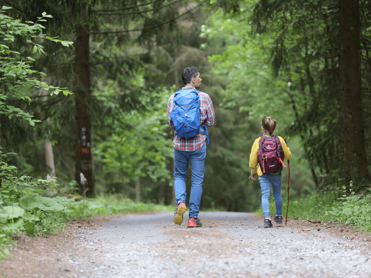 A child hiking with her dad