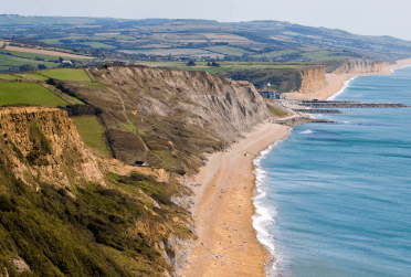 A view parallel to the red cliffs and sands of the Jurassic coastline.