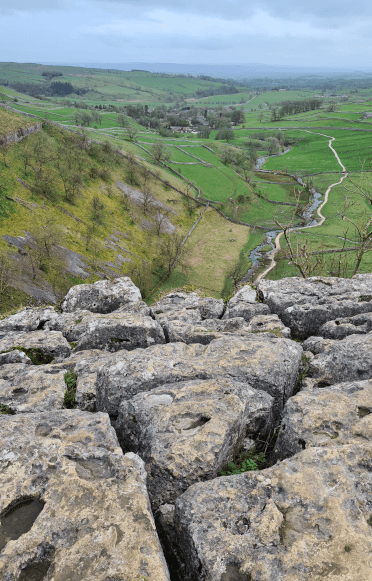 A photo of the limestone pavement atop Malham Cove, where the limestone has split into deeply-cut pavers.
