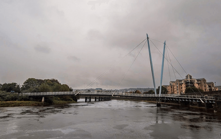 A suspension bridge spans the Lune Estuary.