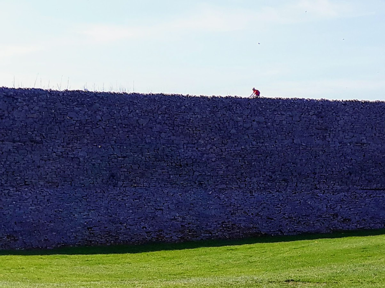 A cyclist riding along the embankment