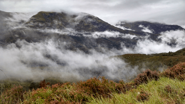 Moorland hills erupt through bands of mist on the inspiring West Highland Way.