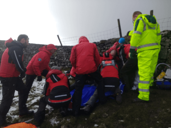 Mountain Rescue at work: the team surround the stretcher.