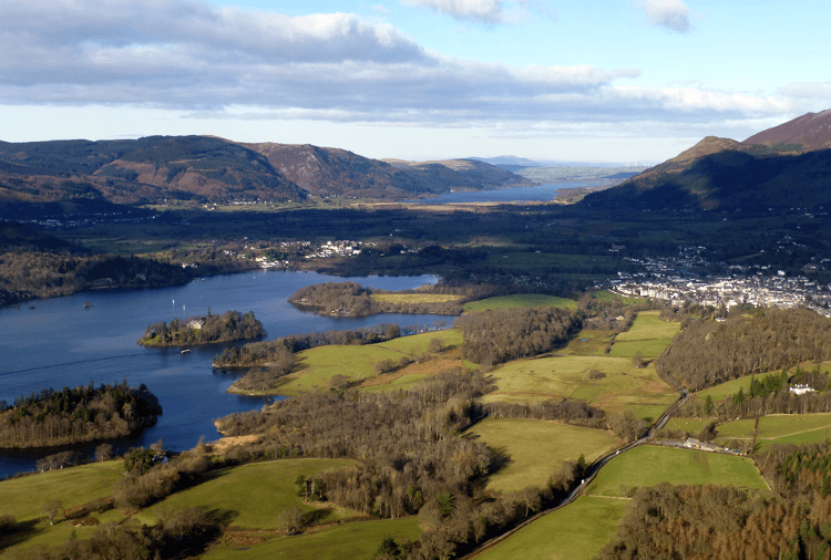 View from Walla Crag over green fields and glittering lakes below on the North Lakes Short Break walking holiday in the UK