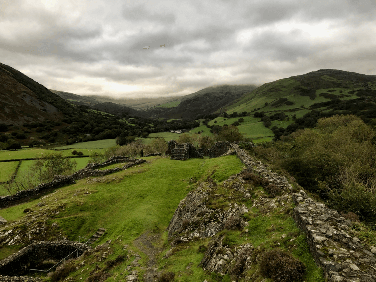 The view north from Castell y Bere: green fields rounding into the foothills of Cader Idris