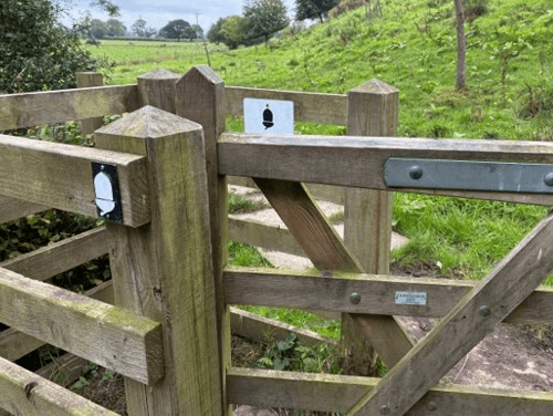 The National Trails' acorn waymarker on a fencepost out on Hadrian's Wall Path.