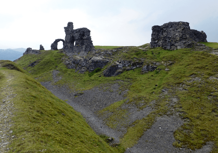 The ruin of Dinas Bran stands proud over the deep dip of Offa's Dyke