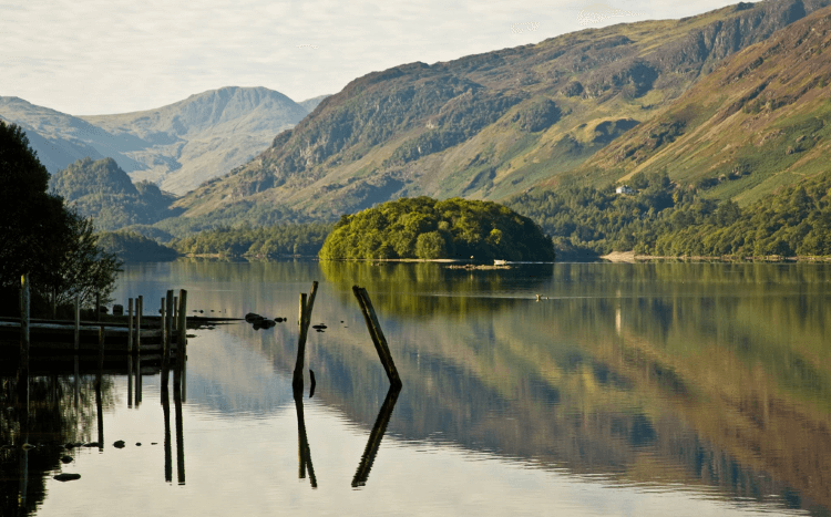 An old jetty sticks out into Derwentwater, as seen from the Lake District's Old Tourist Route.