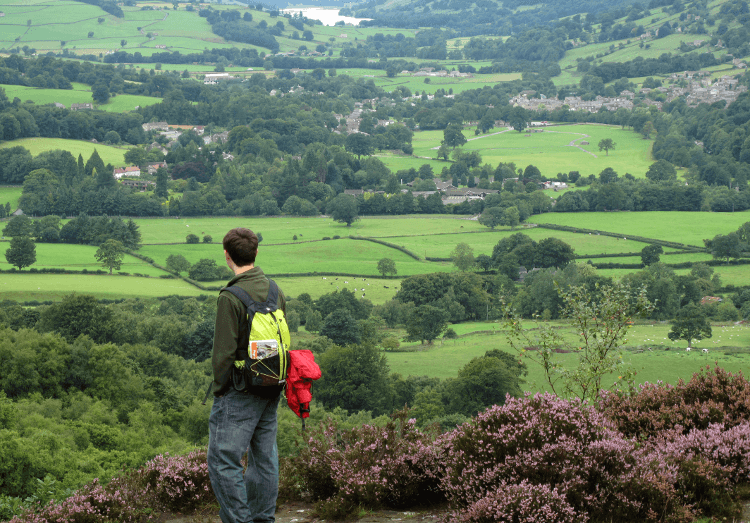 A hiker looking out over the beautiful green scenery of Nidderdale.