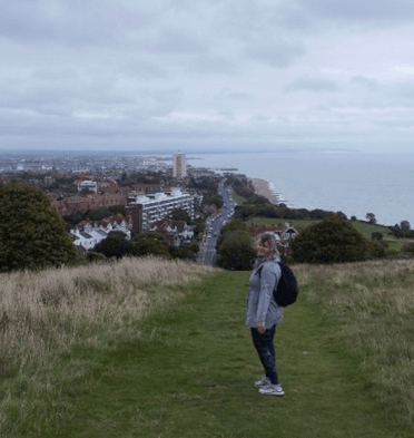 From the footpath on the hills above Eastbourne, you can see the town and its pier in the distance.