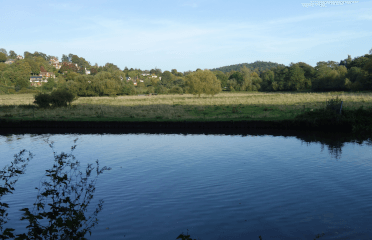 The river is particularly wide beside this farmer's field.