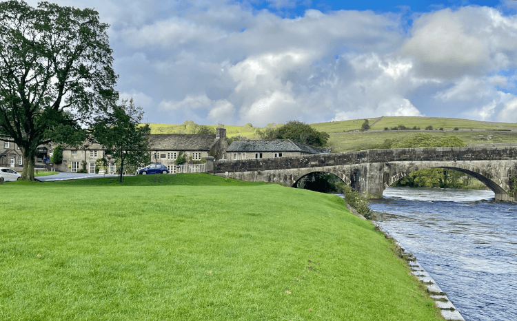 Views over the River Wharfe as it passes Burnsall and under a bridge.