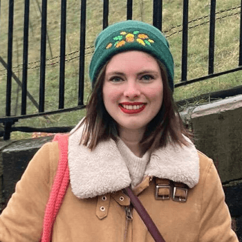 Rosalie, tour operations administrator, stands outdoors in a knitted hat.