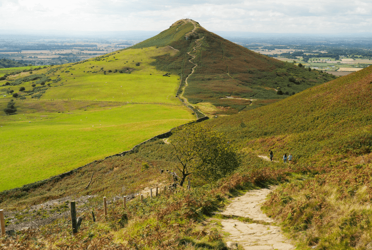 The wild beauty of Roseberry Topping on the Cleveland Way. This unusually shaped peak rises above stone pavement.