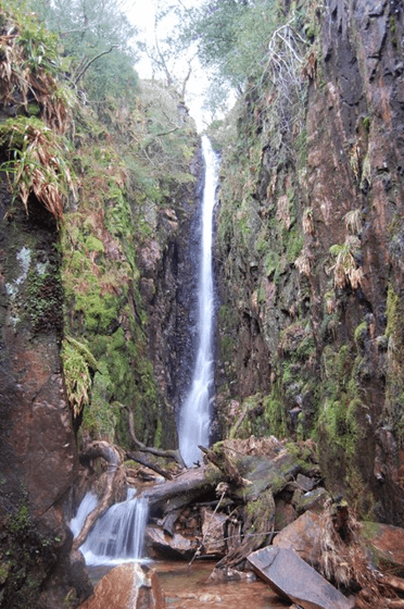 Scale Force at Buttermere by Trevor Harris. Water drops an immense height over stone.