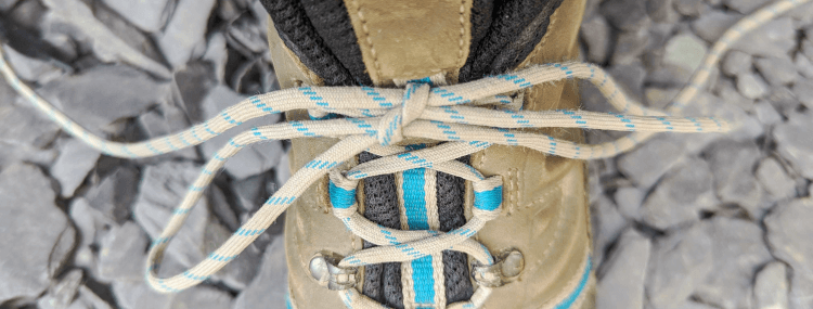 A hiking boot tied with a good, solid bow.