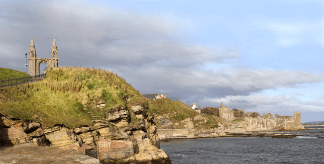 St Andrews Castle sits on a green hilltop above water on the Fife Coastal path
