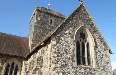 St Martha's Church set before a bright blue sky.