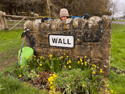 A photo of a walker having fun behind a wall labelled WALL.