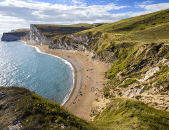 A sandy bay in Dorset viewed from above after a steep climb.