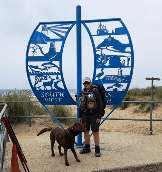 Christine and Gino stand in front of the South West Coast Path statue.