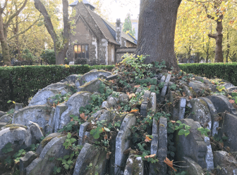 Graves are stacked on their sides around a tree in a London graveyard. The Hardy Tree by Matt Brown.