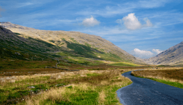 Hardknott Pass in the Lake District by Tim Fields. A narrow ribbon of asphault twines beneath the rocky flanks of Lakeland fells.