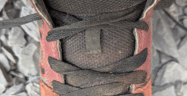 A Five-Ten mountain biking shoe displaying internal gap lacing.