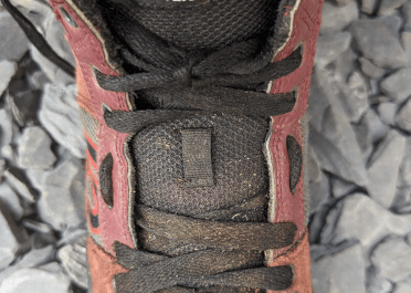 By slackening off the lacing and pulling the shoe upper aside, we can see the way the lace dips in and out of the traditional eyelets to create a more stable gap lacing pattern.