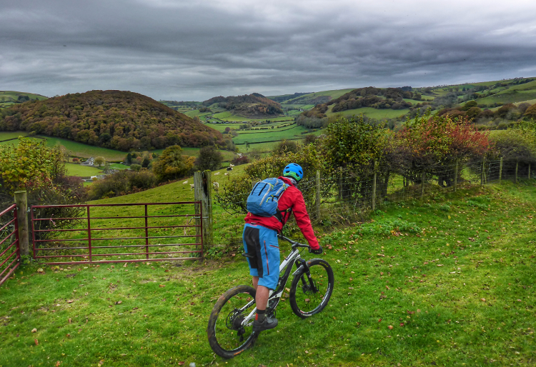 Riding to a countryside gate on the Trans Cambrian Way
