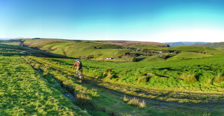 Cycling along a grassed-over byway along the Trans Cambrian Way
