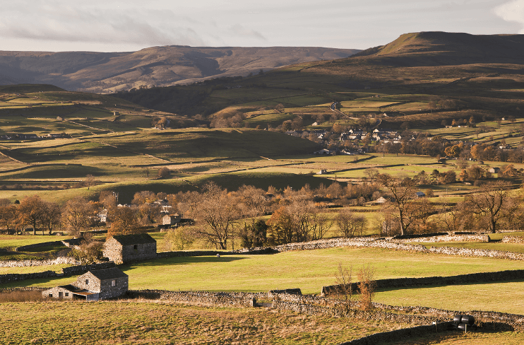 Autumn views over Askrigg towards Penyghent on the Yorkshire Wolds Way walking holiday