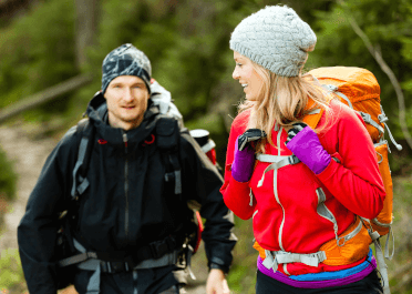 Two walkers out in winter, sporting a range of layered clothing to deal with the changing conditions.
