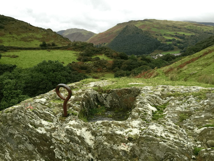 The watering hole cut into the rock above Castell y Bere. A metal hoop protrudes from the stone.