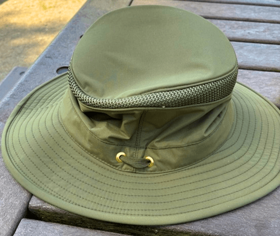 Laura's helpful wide-brimmed hat in a fetching green.