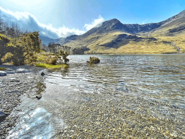 A sunlit lakeside in Cumbria