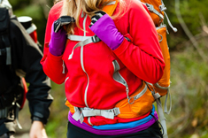 A hiker wears multiple layers to keep warm on a long-distance hike, as well as slim-fitting gloves
